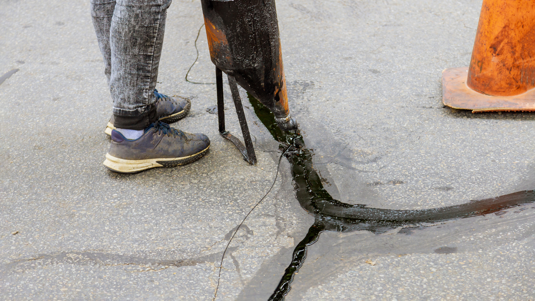 An image of crack repair, a common asphalt driveway maintenance practice.