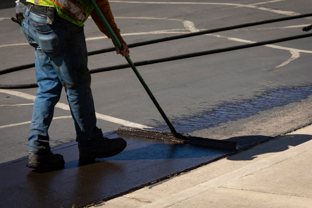 A worker doing asphalt work on the road